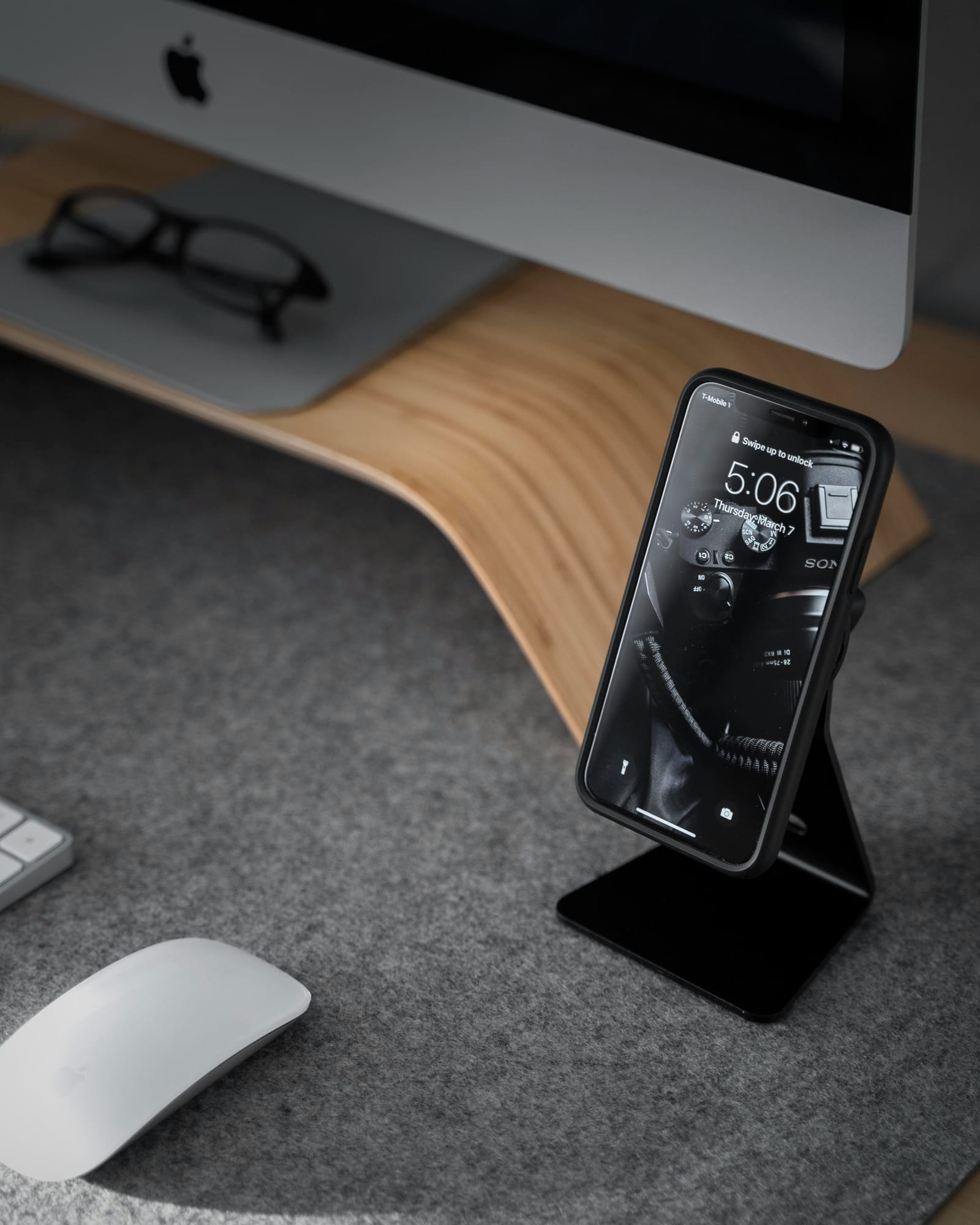 Wireless Charging Stand cradling a bottle on a dark surface