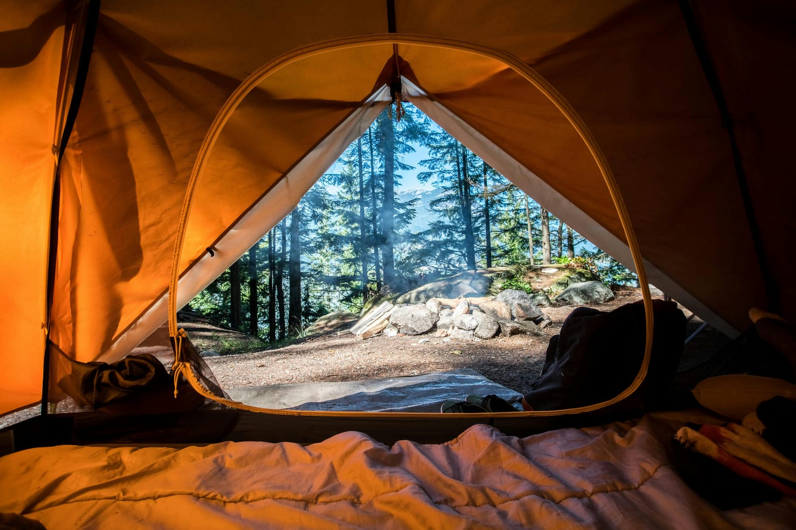 A camp pitched on a mountain plateau at sunset